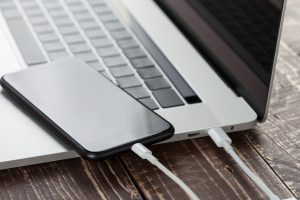 close-up usb cable connect phone and laptop computer new technology concept