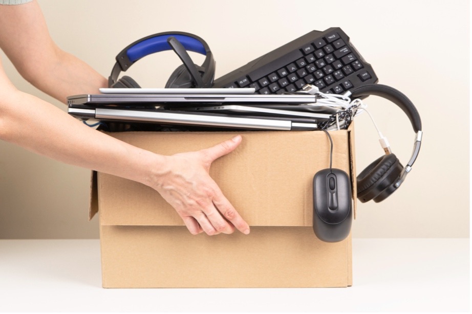 A hand holding a box full of electronics