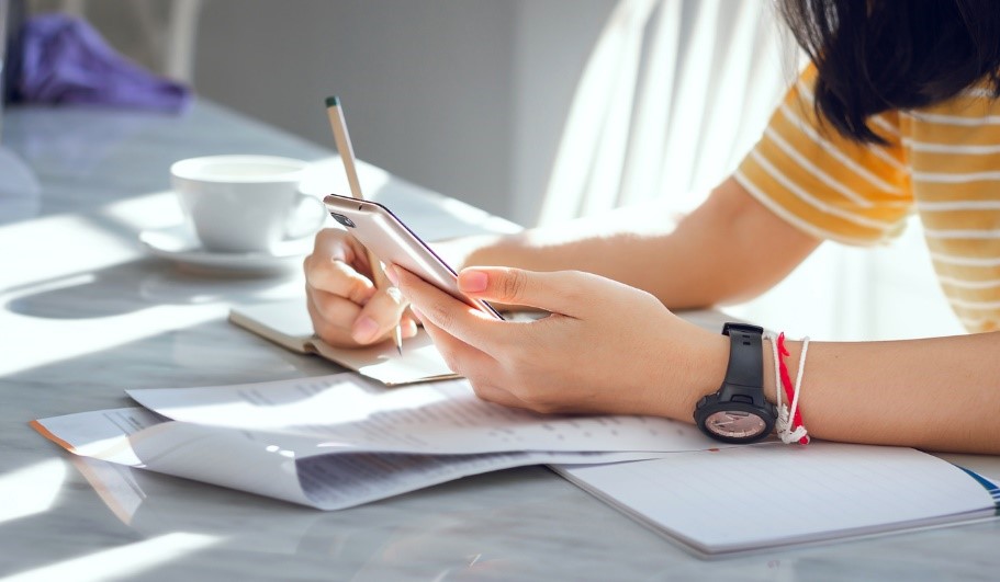 girl using smartphone to help with homework