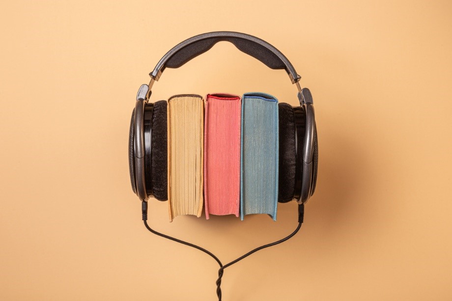library books with headphones around them depicting audiobooks