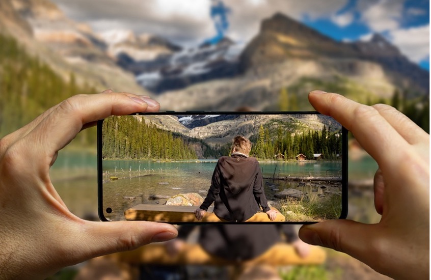 A person taking a picture of a person on a phone