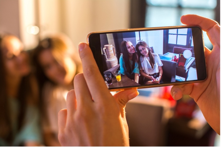 A person taking a picture of two girls